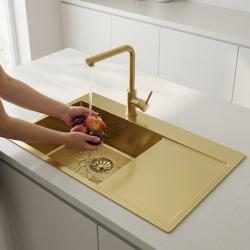 gold-kitchen-sink-with-faucet-washing-apples